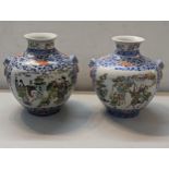 A pair of 20th century Chinese vases decorated in polychrome enamels with figures in garden settings