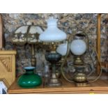 A selection of oil lamps, together with a French style table lamp