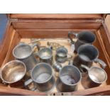 An early 20th century cutlery box and contents to include pewter and silver plated tankards and