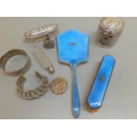 A vintage silver and blue enamelled dressing table hand mirror A/F and a matching brush having inset