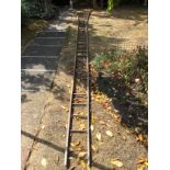 A very long vintage wooden fruit picking ladder, one rung missing, approximately 731cm/24ft (