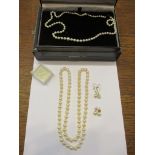 A boxed single strand graduated pearl necklace with silver clasp, another single strand pearl