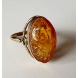 A silver gilt and and amber dress ring having a raised mount, total weight 3.8g, UK ring size O.