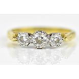 An 18ct yellow gold, white metal and diamond three stone ring, with larger stone to the centre,