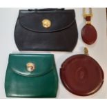 Three vintage Cartier leather purses in green, black and burgundy together with a Cartier gold