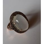 A yellow metal ring, tests as 9ct gold, having a large moonstone on a raised mount, total weight 5.