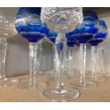 A set of 6 blue overlaid hock glasses and a set of six clear hock glasses Location: 6:2