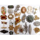 A quantity of vintage brooches to include a Monet gold tone butterfly brooch, mixed paste and seed