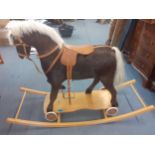 A late 20th century rocking horse covered in horse fur, on wheels or rockers Location: