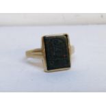 A 9ct gold seal ring the panel carved with a family crest Location: