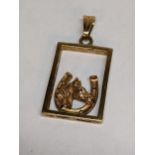 A 9ct gold pendant designed with a horse shoe and horses head Location: