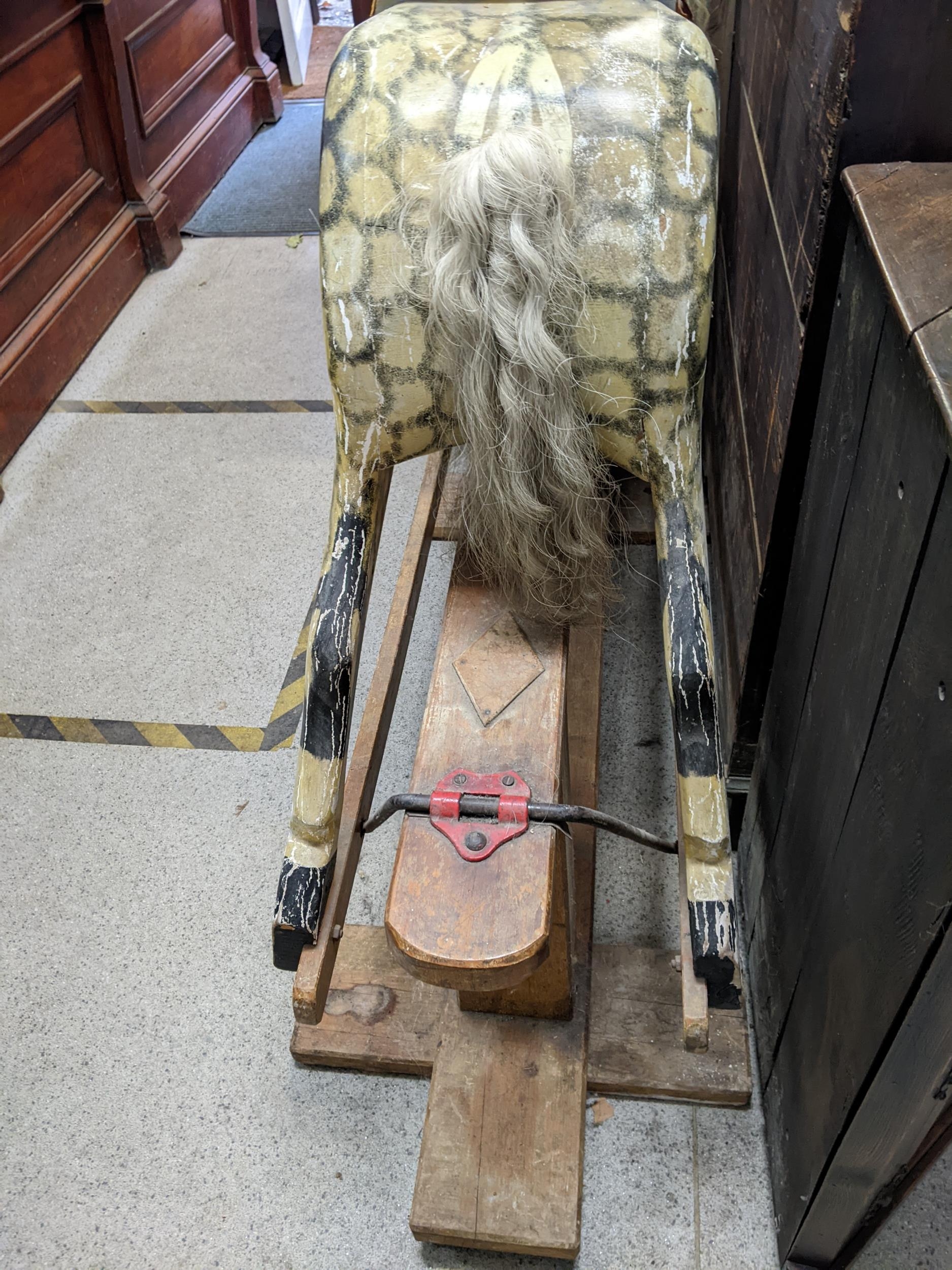 A large early 20th century painted wooden rocking horse with a mane saddle and tail, on a swing base - Image 3 of 6