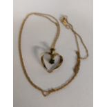 A 9ct gold heart shaped pendant inset with an emerald on a 10ct gold necklace, 1.4g Location: