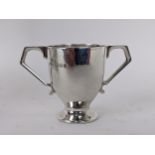 A silver miniature trophy cup with twin handles by Searle & Co Ltd, London 1925, 5cm high, 38g