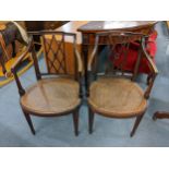 A pair of Edwardian mahogany arm chairs