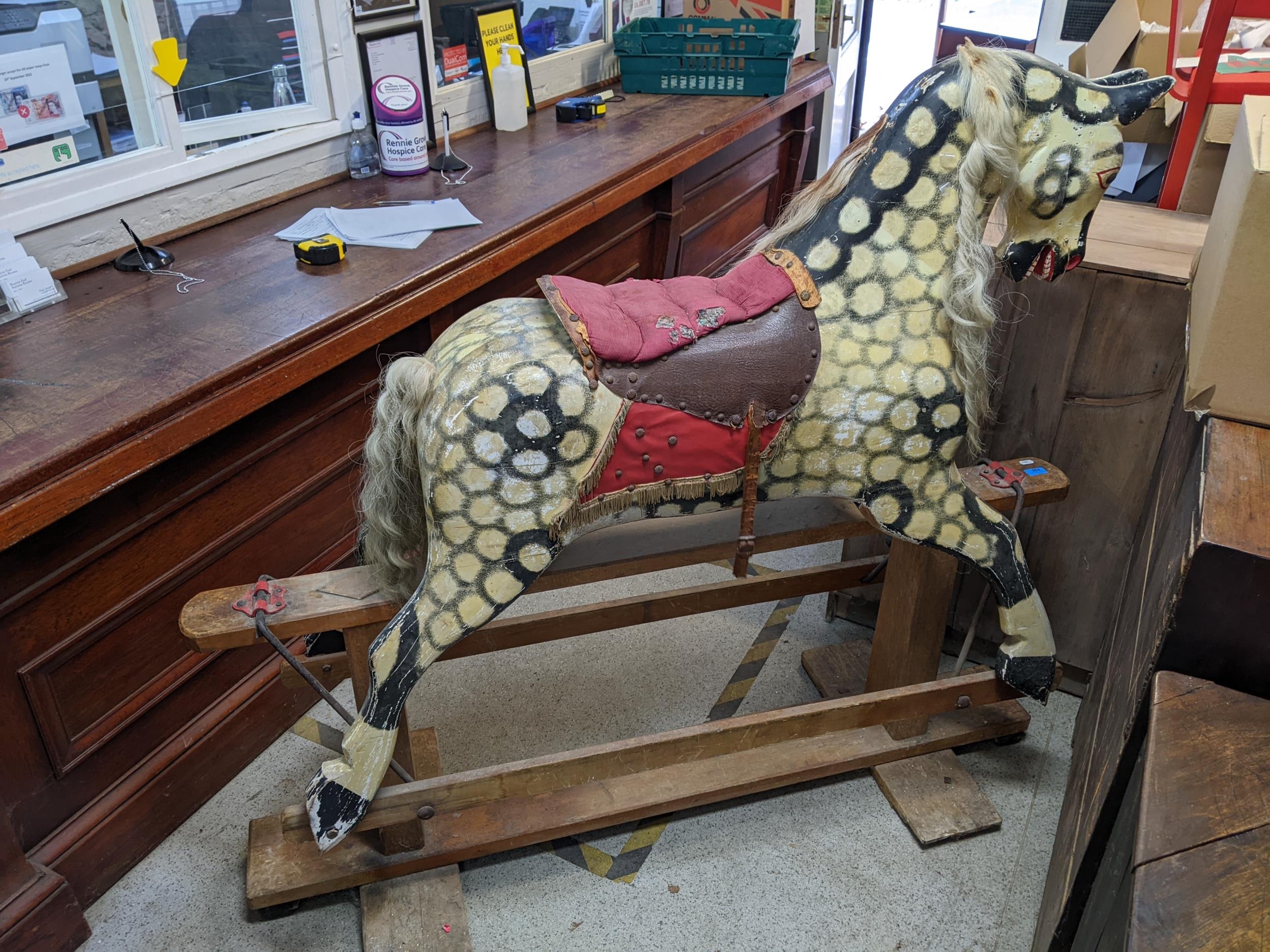 A large early 20th century painted wooden rocking horse with a mane saddle and tail, on a swing base - Image 4 of 6