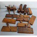 A collection of wood working planes to include a military issue plane