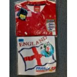 Two new England football shirts comprising a red Umbro Size XXL, new with tags and a white England v