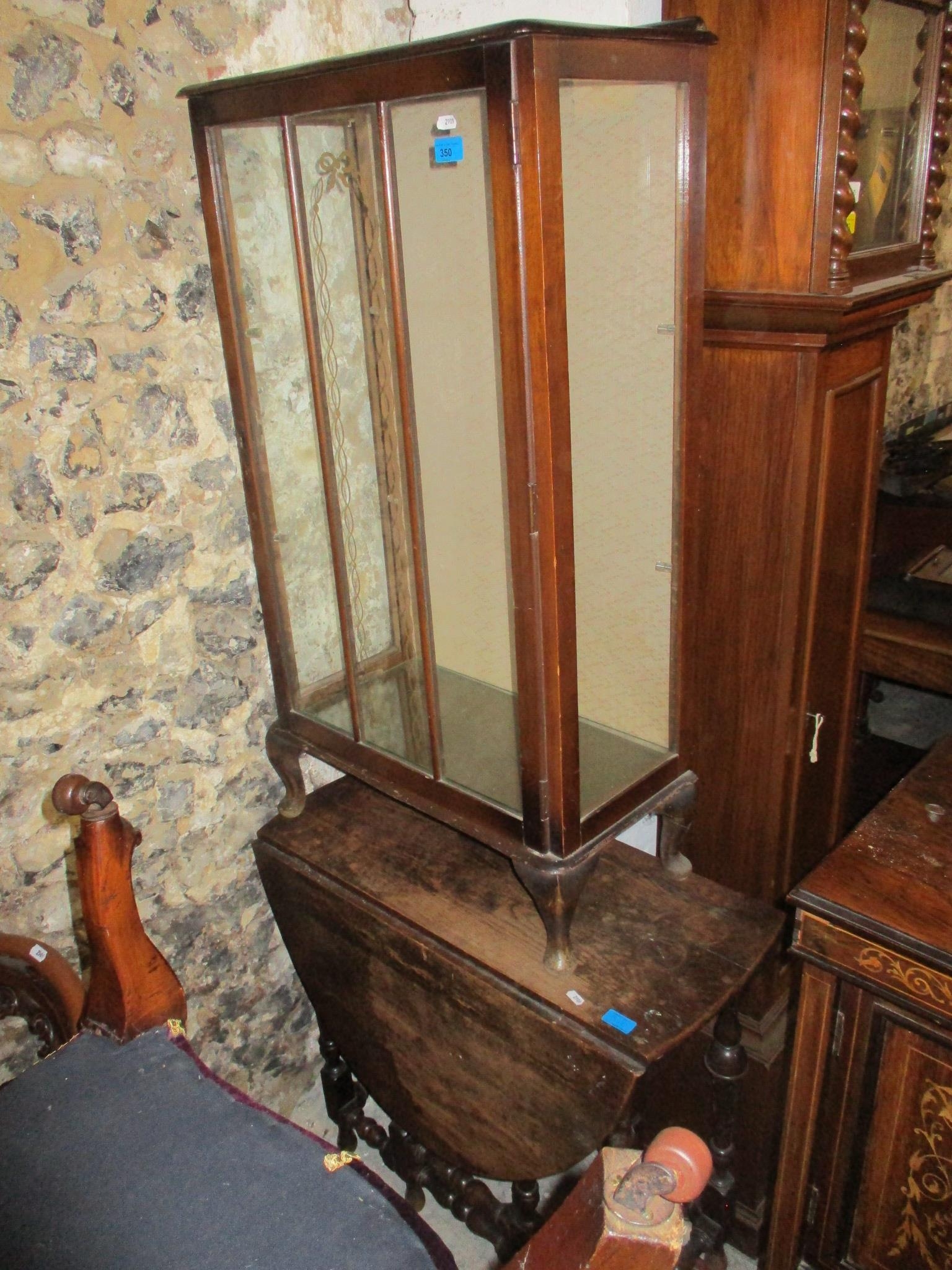 An early 20th century mahogany display cabinet with glazed door and glass internal shelves, on short