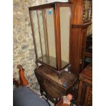 An early 20th century mahogany display cabinet with glazed door and glass internal shelves, on short