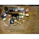 A selection of costume jewellery to include various necklaces, brooches and cufflinks, a carnival