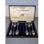 A set of six silver trefoil terminal teaspoons and sugar tong, Sheffield 1916, cased, 63.4g