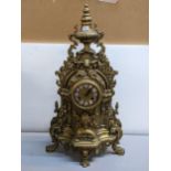 A late 20th century brass cased mantel clock, with c scroll and foliage ornament Location: