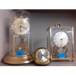 Two mid 20th century brass framed anniversary clocks, a later travel clock and an oak Smiths