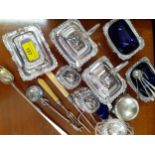 Silver plated condiments with blue glass liners and salt spoons and other items