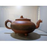A Chinese Yixing terracotta teapot having a dragon head spout and lizard handle finial Location:
