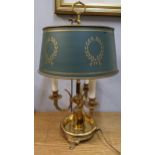 A vintage style Bouillotte gild metal table lamp having three sconces and raised on three feet, 63cm