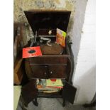 An early to mid 20th century Apollo wind-up gramophone with a selection of singles, LPs and 78rpm