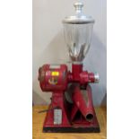 A Hobart vintage shop coffee grinder with a red painted metal body and glass jar Location: plug
