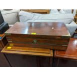 A 19th century mahogany campaign writing slope with brass plaque to the lid and twin carrying