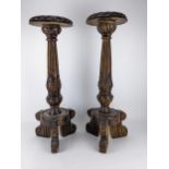 A pair of large late 20th century oak floor standing candlesticks with carved ornament, reeded and