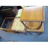 A mid century G-plan style nest of three tables with inset tiles to the largest, along with a