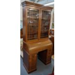 An early 20th century mahogany bookcase having a dental moulded cornice above twin glazed doors,