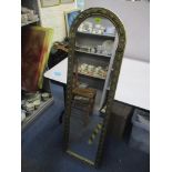 A gilt framed wall mirror with arched top, raised shell and leaf design, 130cm high Location: SL