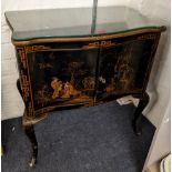 A mid 20th century chinoiserie drinks cabinet decorated with figures and birds and on cabriole legs,