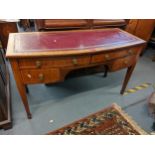An early 20th century mahogany bow fronted desk having a red leather top and four drawers, 74cm h