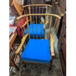 A pair of mid 20th century Ercol style armchairs with spindle backs and blue cushions Location: