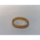 A 22ct gold wedding band, mis-shaped, 3.2g Location: