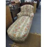 A late Victorian mahogany upholstered day bed with later floral upholstery, on turned legs and