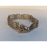 A 9ct gold gate link bracelet having a heart shaped padlock clasp, 9.1g Location: