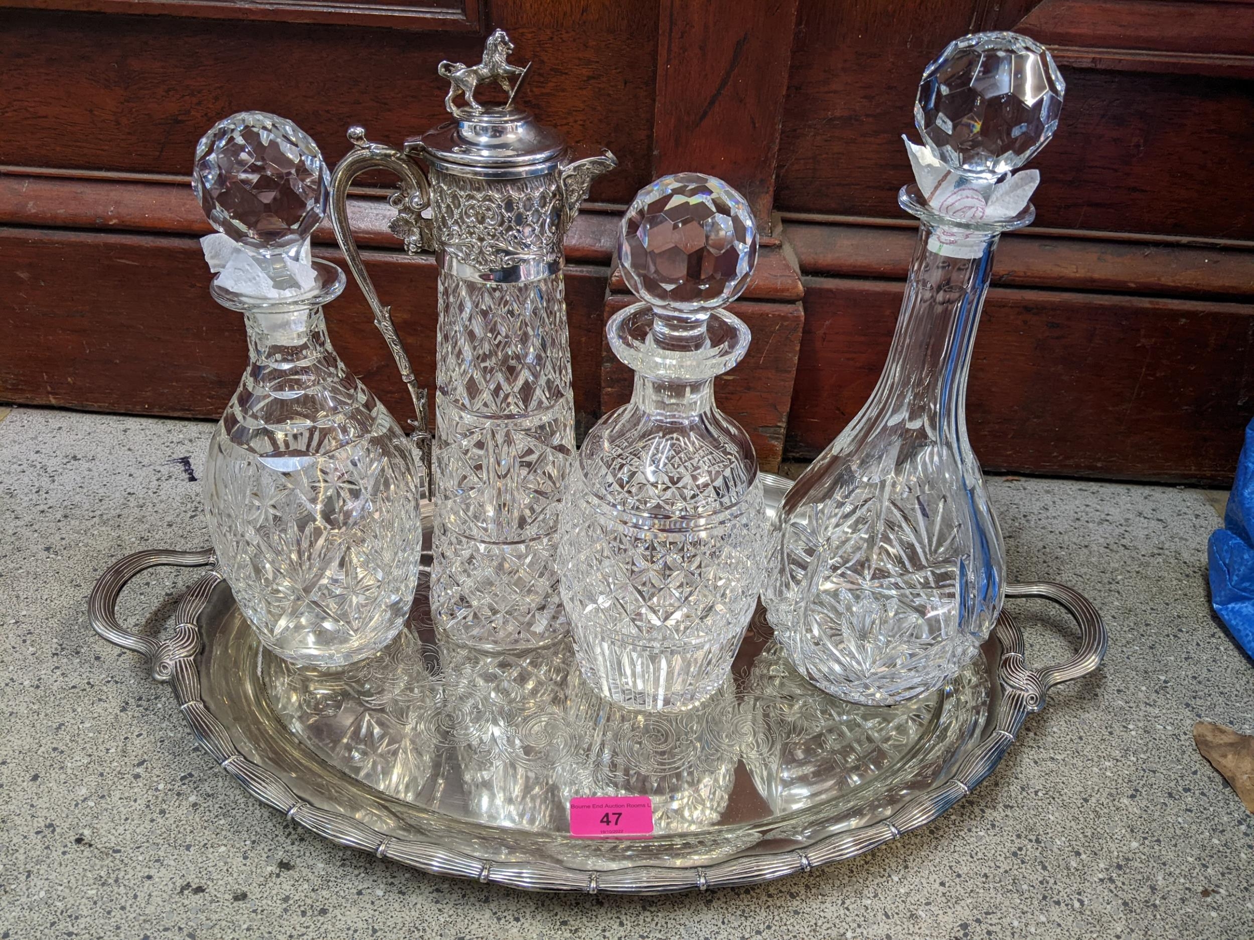 A silver plated tray, a claret jug and three decanters Location: