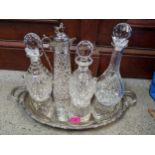 A silver plated tray, a claret jug and three decanters Location: