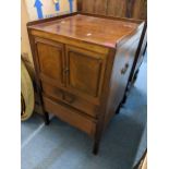 A Georgian mahogany bedside pot cupboard having two panelled doors above two drawers 79.5cm h x 48cm