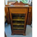 An Edwardian mahogany music cabinet having a broken swan neck pediment and single glazed door, 102cm