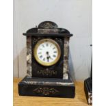 A black slate and marble cased mantel clock with an enamelled dial on a French movement Location: