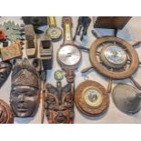 A mixed lot of treen items to include tribal style masks, a cuckoo clock A/F, barometer, woodworking